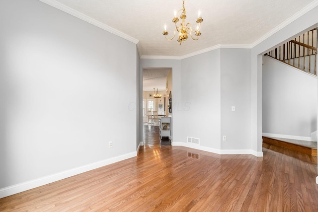 544 Courtright Ct, Pickerington, OH 43147 - unfurnished room with a chandelier, light wood-style flooring, stairs, ornamental molding, and baseboards