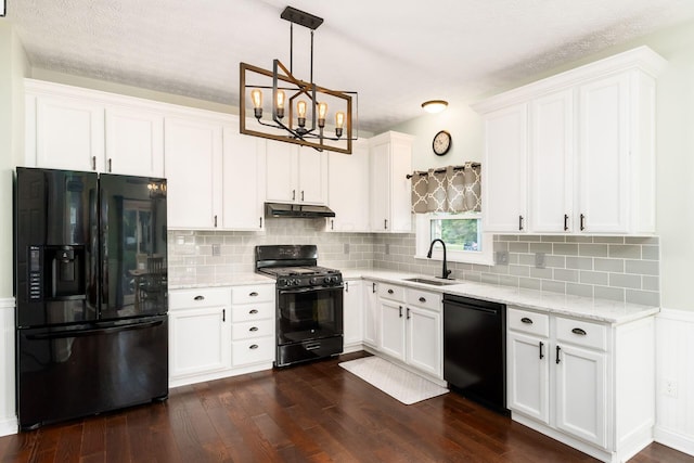 544 Courtright Ct, Pickerington, OH 43147 - kitchen with black appliances, under cabinet range hood, a sink, dark wood finished floors, and white cabinets