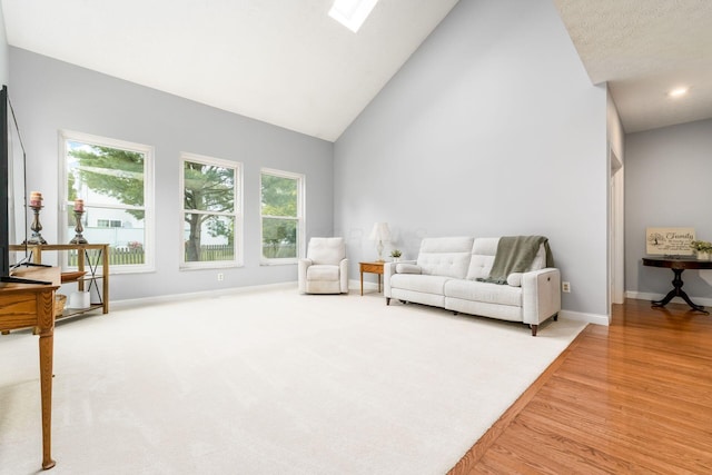 544 Courtright Ct, Pickerington, OH 43147 - living room with high vaulted ceiling, baseboards, wood finished floors, and a skylight