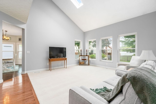 544 Courtright Ct, Pickerington, OH 43147 - living area with high vaulted ceiling, a chandelier, healthy amount of natural light, wood finished floors, and baseboards