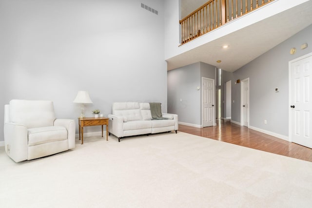 544 Courtright Ct, Pickerington, OH 43147 - living area featuring carpet, baseboards, a high ceiling, wood finished floors, and recessed lighting