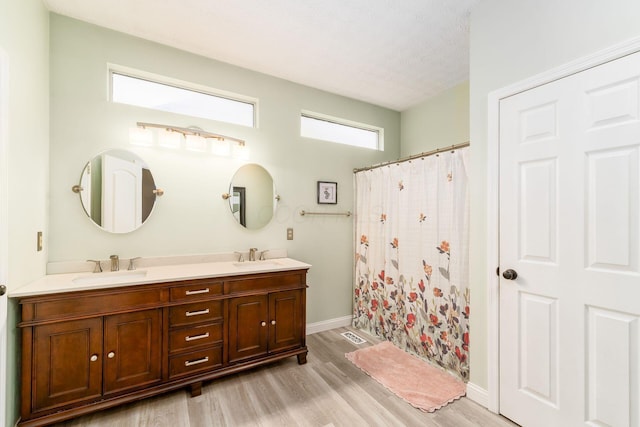 544 Courtright Ct, Pickerington, OH 43147 - full bath with double vanity, wood finished floors, curtained shower, and baseboards