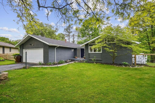 710 Cloverleaf Ct, Mansfield, OH 44904 - view of front of home with asphalt driveway, an attached garage, and a chimney