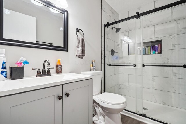 710 Cloverleaf Ct, Mansfield, OH 44904 - full bathroom with toilet, vanity, a stall shower, and wood finished floors