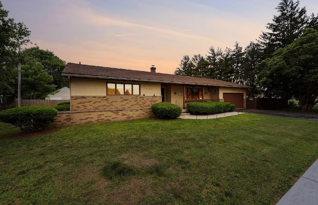 300 Stockbridge Rd, Columbus, OH 43207 - ranch-style house with an attached garage, brick siding, driveway, and a chimney