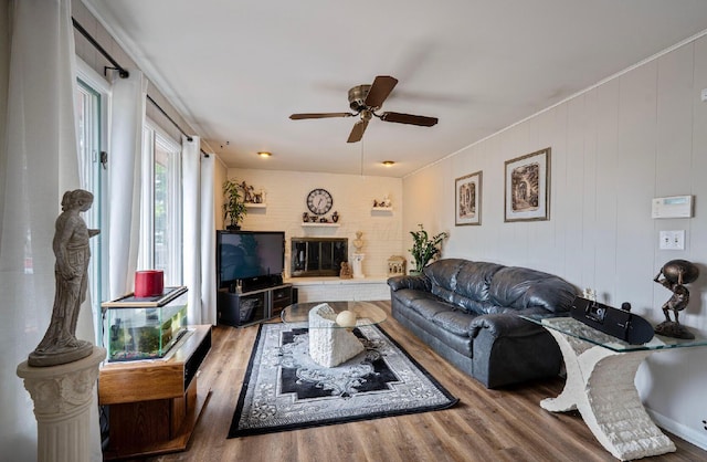 300 Stockbridge Rd, Columbus, OH 43207 - living room with ceiling fan, wood finished floors, and a brick fireplace