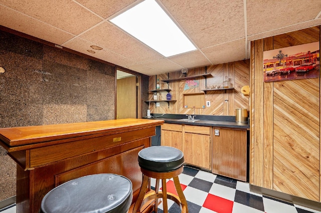 300 Stockbridge Rd, Columbus, OH 43207 - indoor dry bar featuring a paneled ceiling, dark flooring, and wood walls