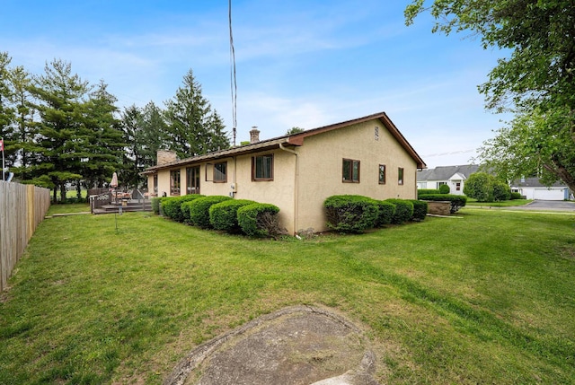 300 Stockbridge Rd, Columbus, OH 43207 - view of property exterior with a deck, a chimney, and stucco siding