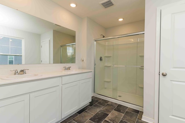 5914 Damsel Dr, Columbus, OH 43232 - bathroom with a stall shower, double vanity, and recessed lighting