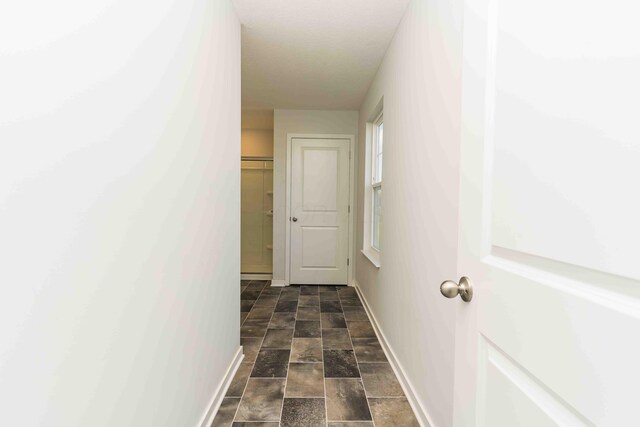 5914 Damsel Dr, Columbus, OH 43232 - corridor featuring baseboards and stone finish floors