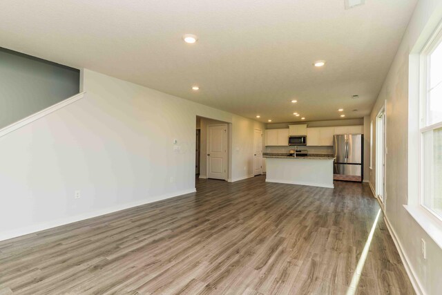 5914 Damsel Dr, Columbus, OH 43232 - unfurnished living room with recessed lighting, wood finished floors, and baseboards