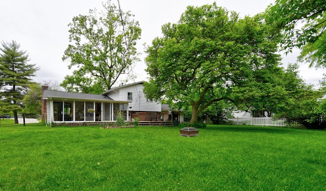 4200 Rudy Rd, Columbus, OH 43214 - view of yard with a sunroom, a wooden deck, and a fire pit
