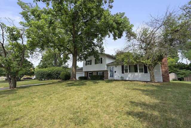 4200 Rudy Rd, Columbus, OH 43214 - split level home with a front yard, a garage, and brick siding