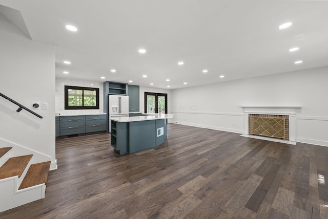 4200 Rudy Rd, Columbus, OH 43214 - kitchen with white refrigerator with ice dispenser, a kitchen island, healthy amount of natural light, dark wood-style flooring, and recessed lighting