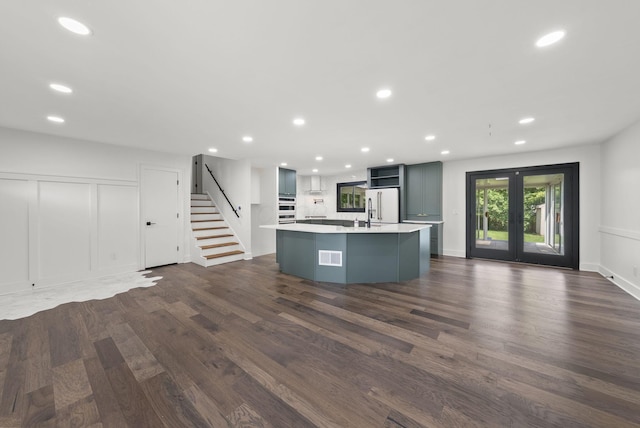 4200 Rudy Rd, Columbus, OH 43214 - kitchen featuring white appliances, recessed lighting, dark wood-type flooring, light countertops, and a center island with sink