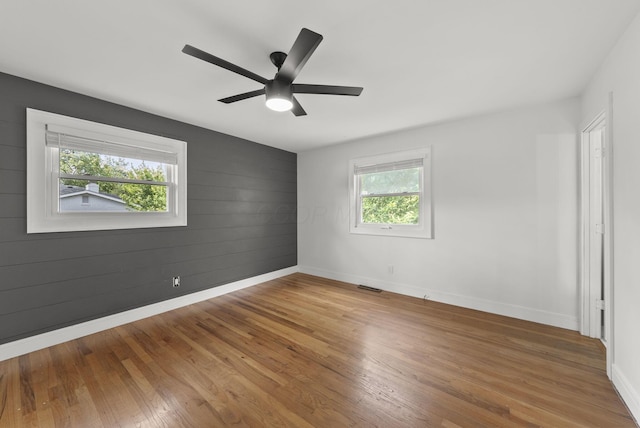 4200 Rudy Rd, Columbus, OH 43214 - unfurnished room with wood finished floors, a ceiling fan, and wooden walls