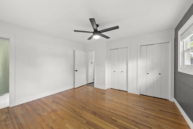4200 Rudy Rd, Columbus, OH 43214 - unfurnished bedroom featuring multiple closets, wood finished floors, and a ceiling fan