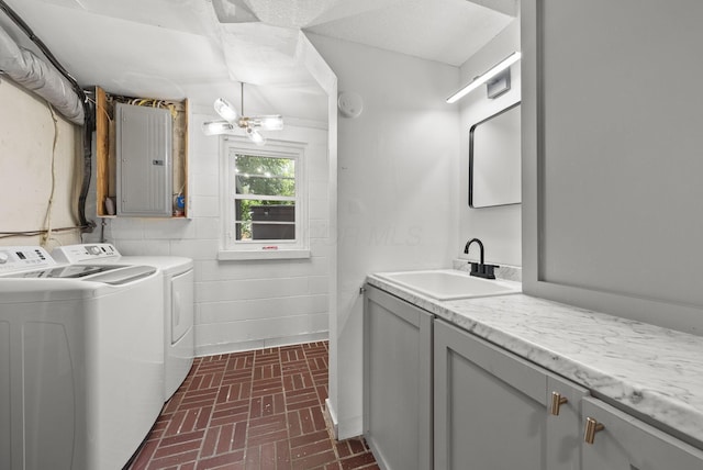4200 Rudy Rd, Columbus, OH 43214 - laundry room with electric panel, independent washer and dryer, brick patterned flooring, and cabinet space