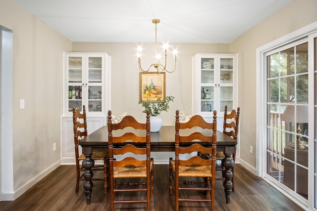 2194 Worthingwoods Blvd, Powell, OH 43065 - dining room with dark wood finished floors, a chandelier, and baseboards