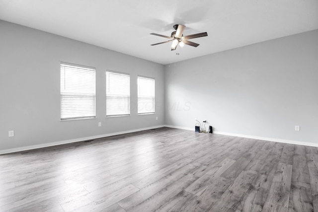 294 Shady Hollow Dr, Commercial Point, OH 43116 - spare room featuring a ceiling fan, wood finished floors, and baseboards