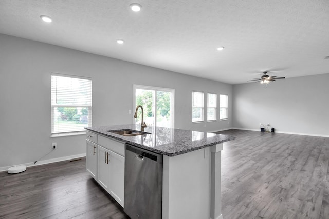 294 Shady Hollow Dr, Commercial Point, OH 43116 - kitchen featuring dishwasher, a sink, a kitchen island with sink, stone counters, and baseboards