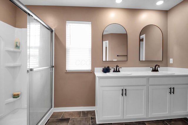 294 Shady Hollow Dr, Commercial Point, OH 43116 - bathroom featuring double vanity, a stall shower, baseboards, plenty of natural light, and recessed lighting