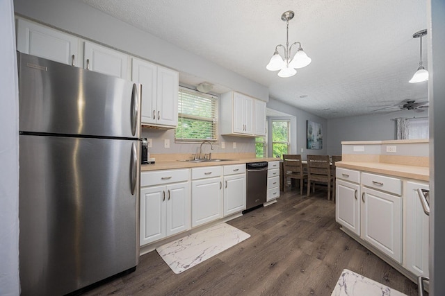 1427 Trabue Woods Blvd, Columbus, OH 43228 - kitchen with stainless steel appliances, a sink, white cabinets, and a textured ceiling