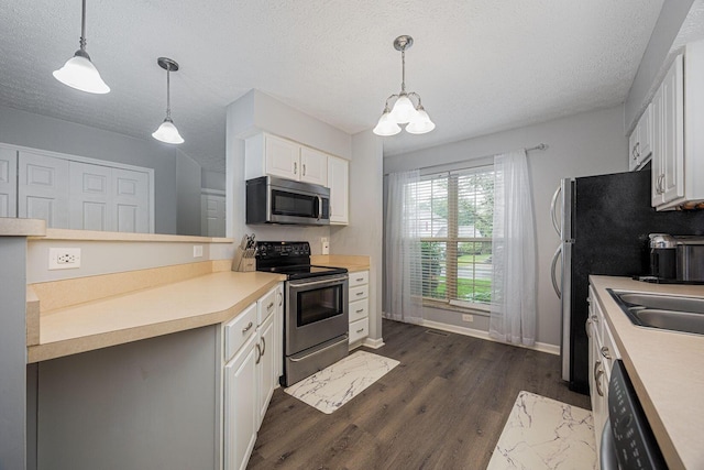 1427 Trabue Woods Blvd, Columbus, OH 43228 - kitchen with stainless steel appliances, dark wood-style flooring, white cabinetry, light countertops, and a textured ceiling
