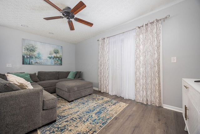 1427 Trabue Woods Blvd, Columbus, OH 43228 - living area featuring wood finished floors, a textured ceiling, ceiling fan, and baseboards