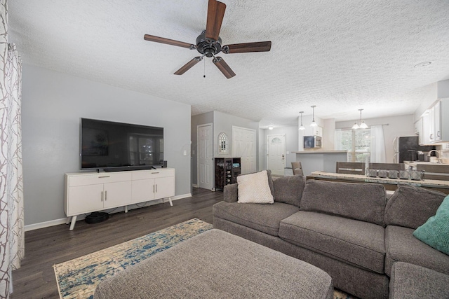1427 Trabue Woods Blvd, Columbus, OH 43228 - living room featuring ceiling fan, dark wood-style floors, baseboards, and a textured ceiling