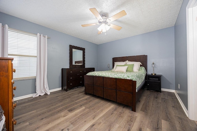 1427 Trabue Woods Blvd, Columbus, OH 43228 - bedroom with wood finished floors, a textured ceiling, baseboards, and a ceiling fan