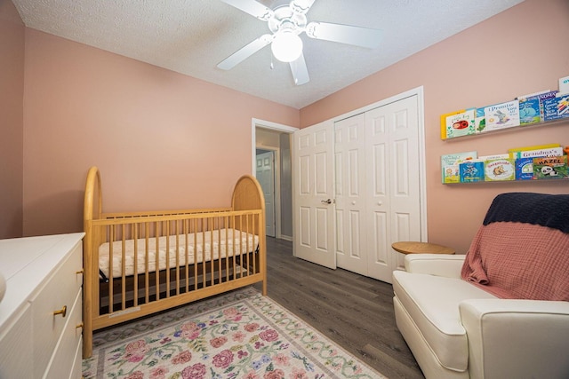1427 Trabue Woods Blvd, Columbus, OH 43228 - bedroom featuring wood finished floors, a closet, a nursery area, and a ceiling fan