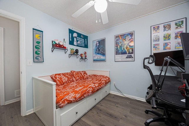 1427 Trabue Woods Blvd, Columbus, OH 43228 - bedroom featuring wood finished floors, a textured ceiling, baseboards, and ceiling fan