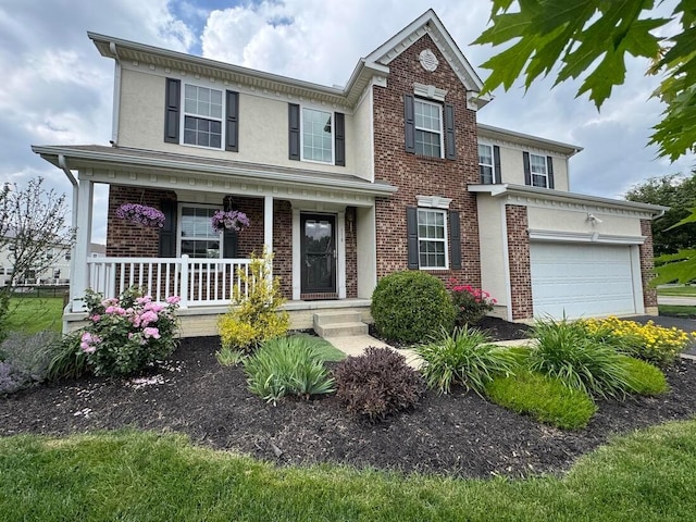 118 Firestone Dr, Delaware, OH 43015 - view of front of property featuring a porch, brick siding, stucco siding, and driveway
