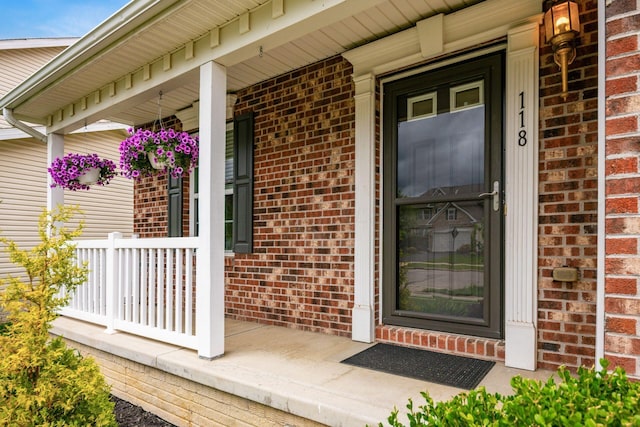 118 Firestone Dr, Delaware, OH 43015 - view of exterior entry with a porch and brick siding