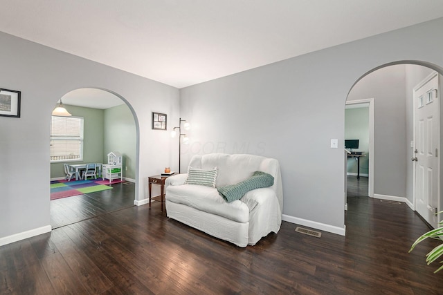 118 Firestone Dr, Delaware, OH 43015 - living area with arched walkways, wood finished floors, and baseboards