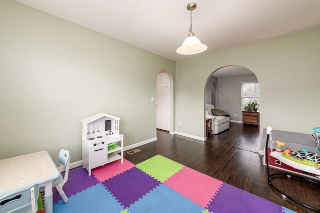 118 Firestone Dr, Delaware, OH 43015 - rec room featuring arched walkways, wood finished floors, and baseboards