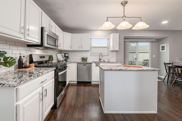 118 Firestone Dr, Delaware, OH 43015 - kitchen featuring appliances with stainless steel finishes, dark wood-style flooring, white cabinets, tasteful backsplash, and recessed lighting