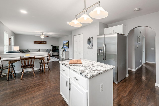 118 Firestone Dr, Delaware, OH 43015 - kitchen with stainless steel fridge, arched walkways, open floor plan, a ceiling fan, and dark wood finished floors