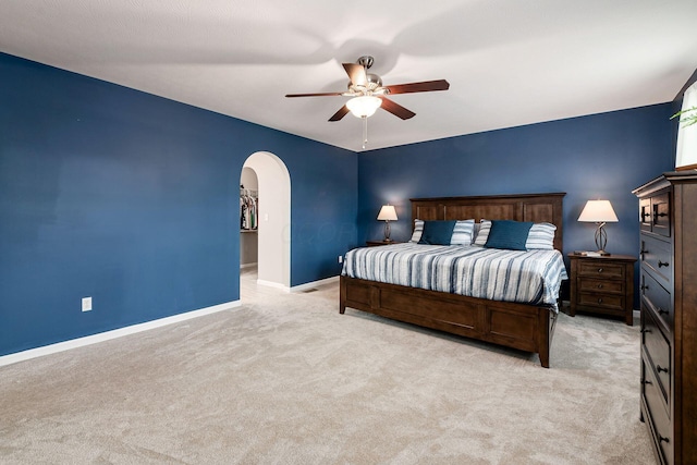 118 Firestone Dr, Delaware, OH 43015 - bedroom with arched walkways, light colored carpet, baseboards, and ceiling fan