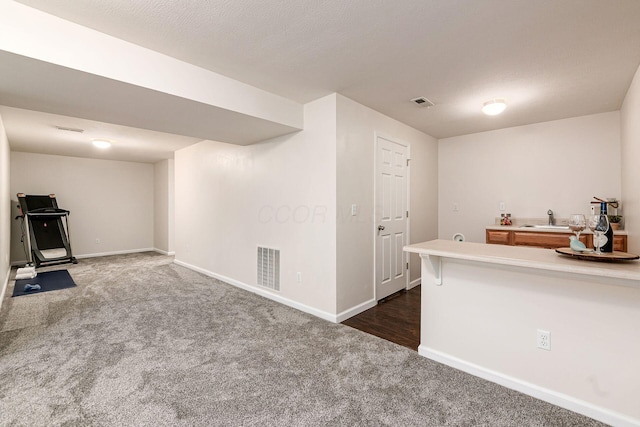 118 Firestone Dr, Delaware, OH 43015 - kitchen with dark colored carpet, a sink, baseboards, and light countertops