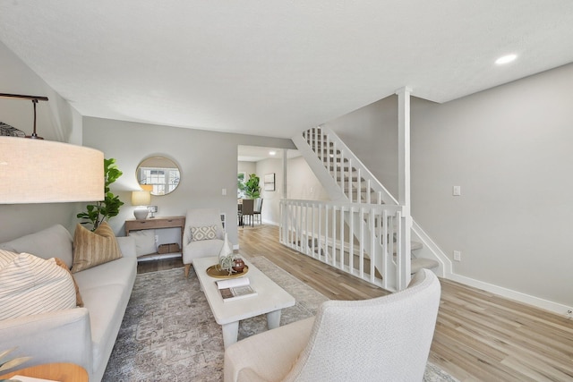 894 Noddymill Ln E Unit 28E, Columbus, OH 43085 - living room with wood finished floors, baseboards, recessed lighting, and stairway