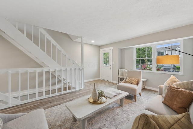 894 Noddymill Ln E Unit 28E, Columbus, OH 43085 - living room with wood finished floors, stairs, baseboards, recessed lighting, and a textured ceiling