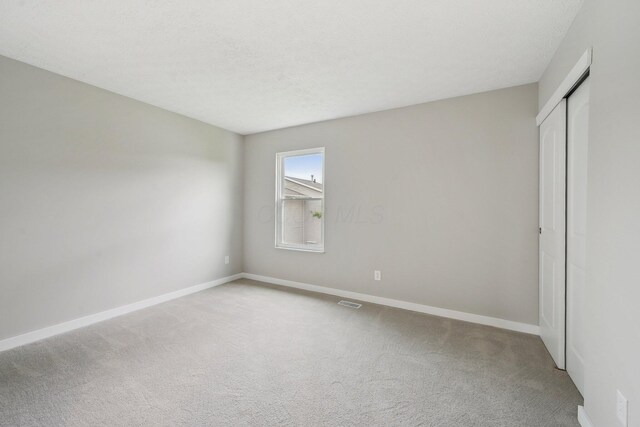 894 Noddymill Ln E Unit 28E, Columbus, OH 43085 - unfurnished bedroom with carpet flooring, baseboards, and a closet
