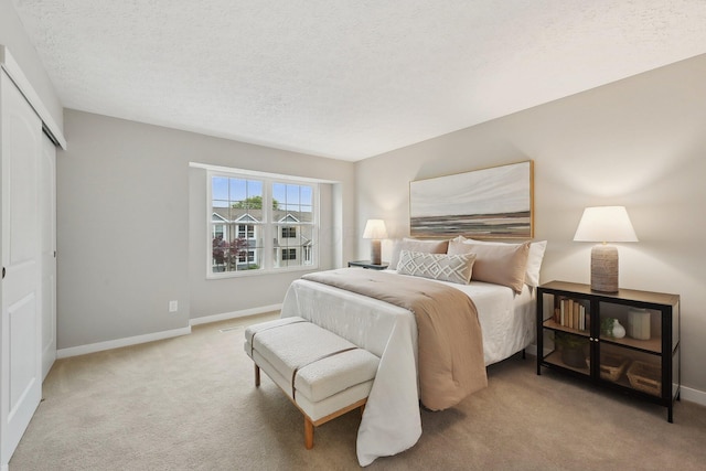 894 Noddymill Ln E Unit 28E, Columbus, OH 43085 - carpeted bedroom with baseboards, a textured ceiling, and a closet
