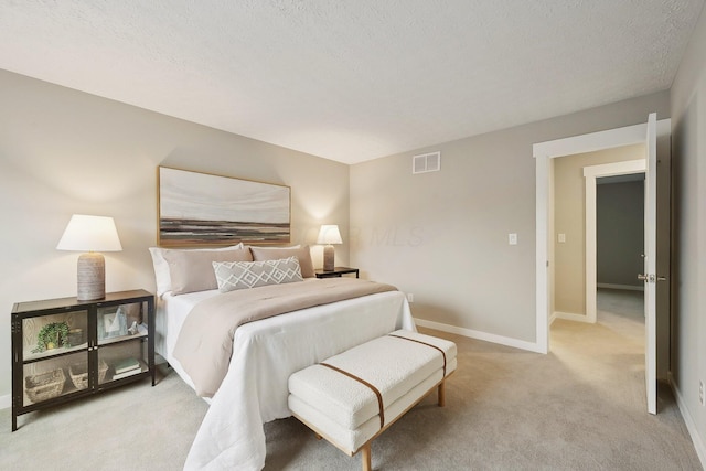 894 Noddymill Ln E Unit 28E, Columbus, OH 43085 - bedroom with light carpet, baseboards, and a textured ceiling
