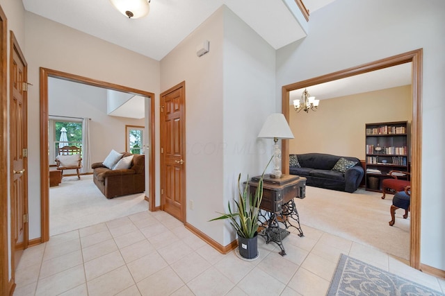 6962 Whitetail Ln, Westerville, OH 43082 - hallway with light carpet, a chandelier, light tile patterned floors, and baseboards
