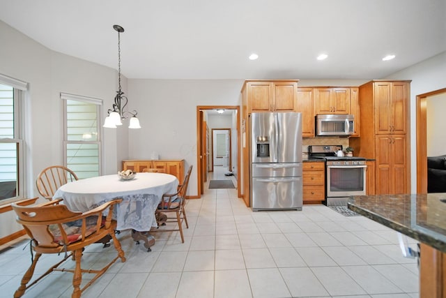 6962 Whitetail Ln, Westerville, OH 43082 - kitchen featuring appliances with stainless steel finishes, backsplash, a chandelier, decorative light fixtures, and recessed lighting