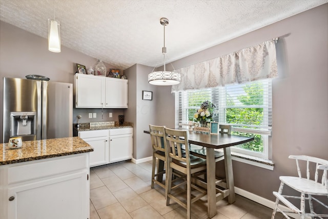 5718 Brook Hollow Dr, Hilliard, OH 43026 - kitchen featuring stainless steel fridge, a textured ceiling, white cabinets, baseboards, and light tile patterned floors