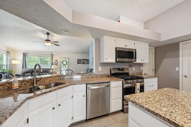 5718 Brook Hollow Dr, Hilliard, OH 43026 - kitchen with appliances with stainless steel finishes, a textured ceiling, a sink, light stone countertops, and white cabinets
